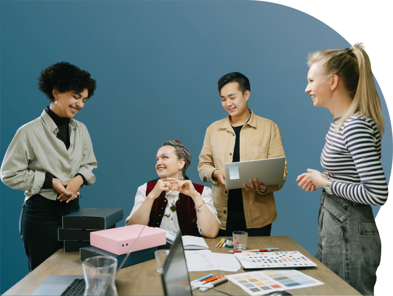 Digital MArketing team standing around a desk